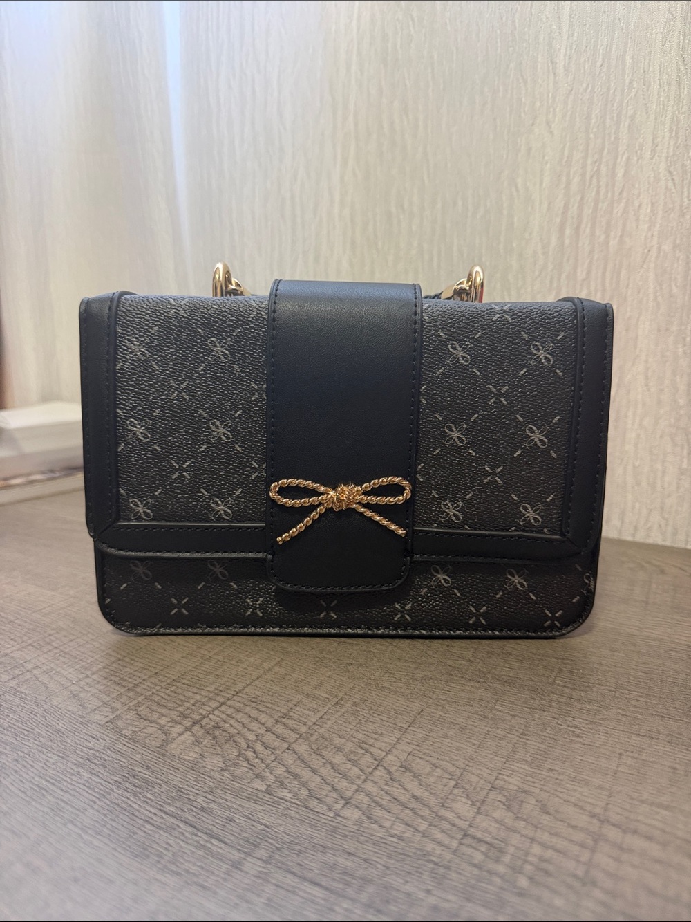 Elegant Black Crossbody Bag with Gold Bow Accent